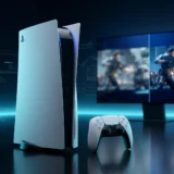 Black and white PlayStation 5 console next to a DualSense controller with a high-resolution game scene behind it