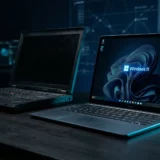 Laptop running Windows 11 showing File Explorer and a cloud backup icon in cyan light on a dark background